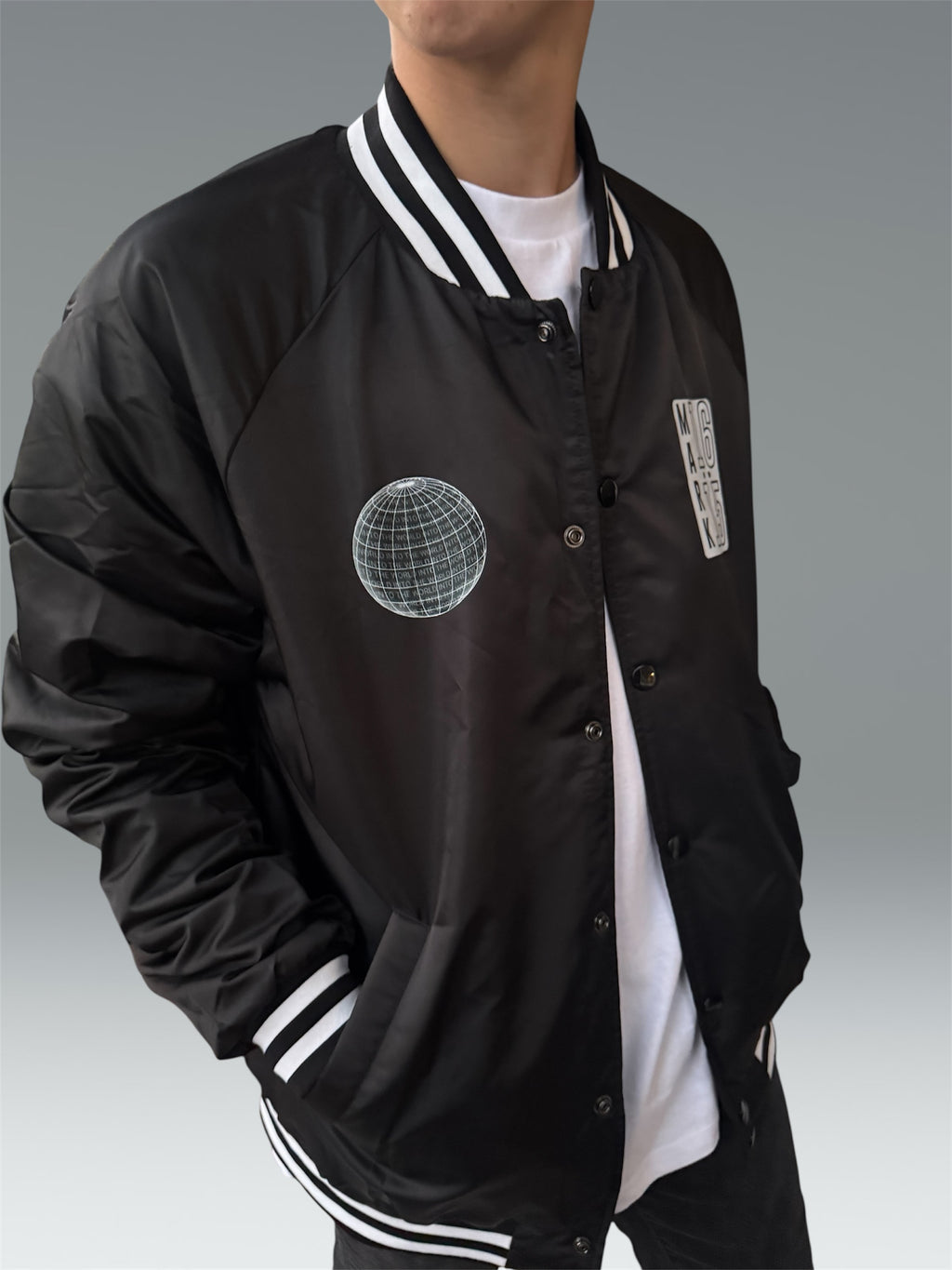 INTO THE WORLD VARSITY BOMBER JACKET