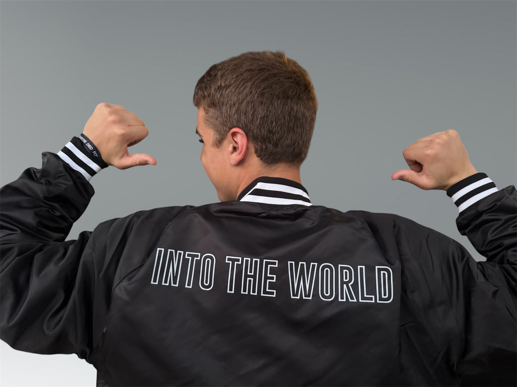 INTO THE WORLD VARSITY BOMBER JACKET